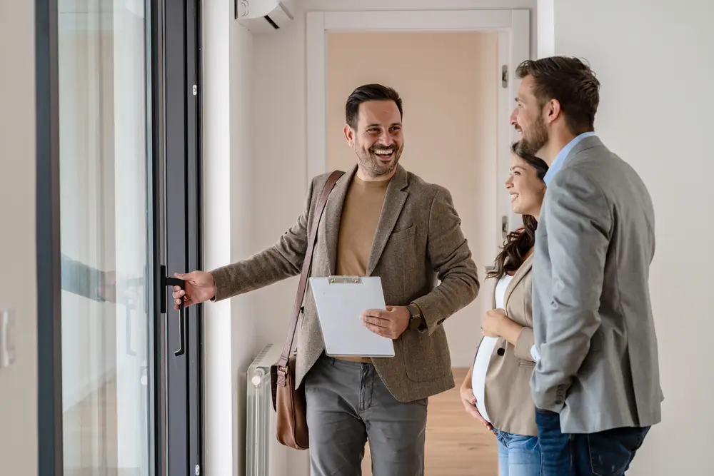 New homeowners holding keys outside their Perth property